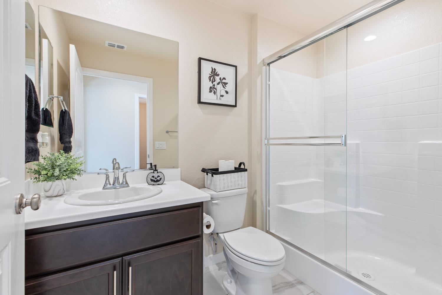 1202 Impression Street Turlock, CA 95380 - Photo 13 of 35 a bathroom with a sink toilet and shower