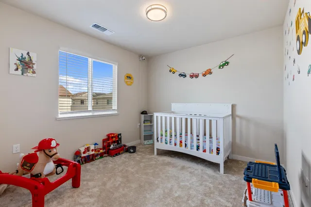 a bedroom with furniture and a window