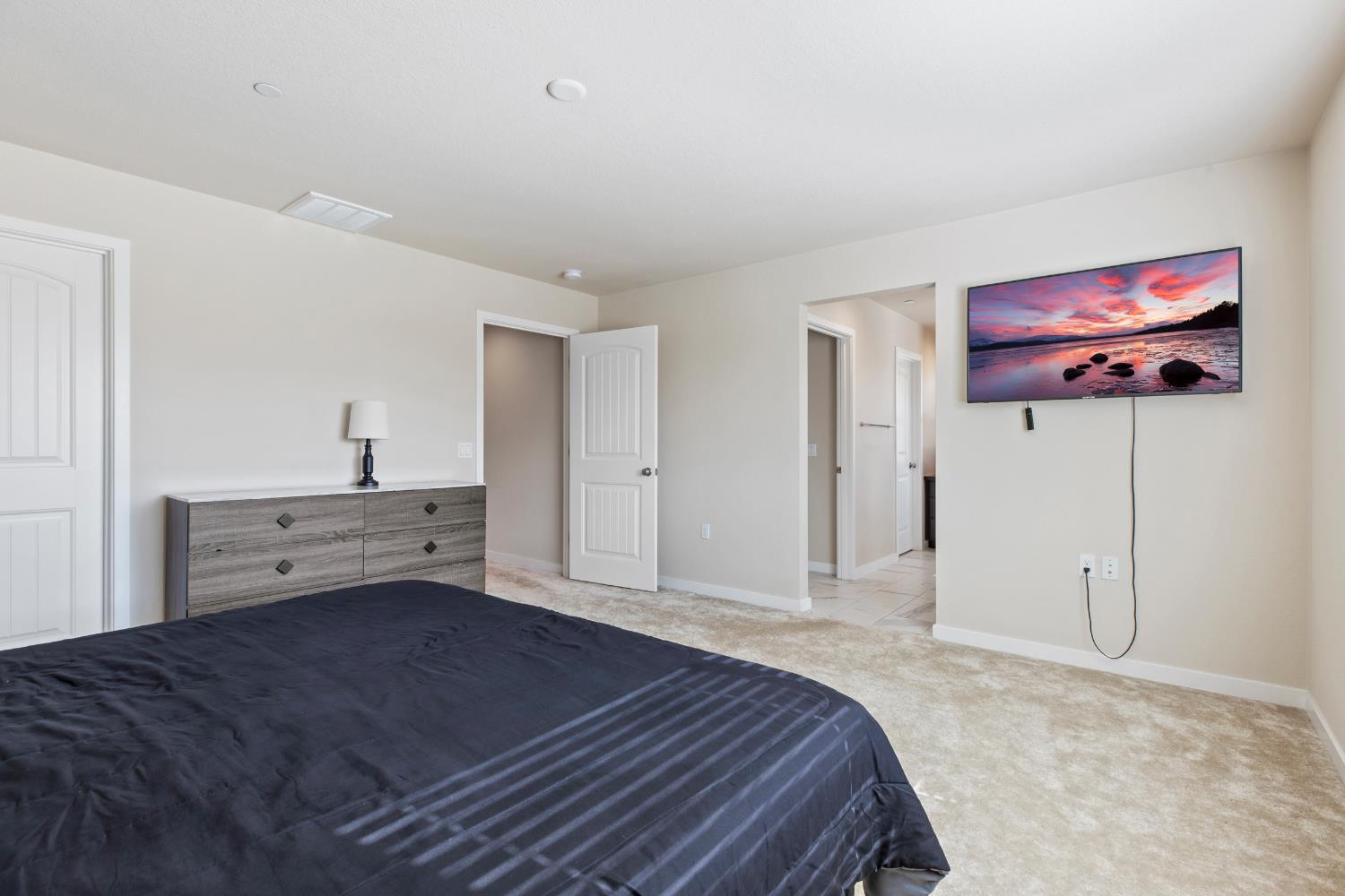 1202 Impression Street Turlock, CA 95380 - Photo 24 of 35 a bedroom with a bed and a view of kitchen