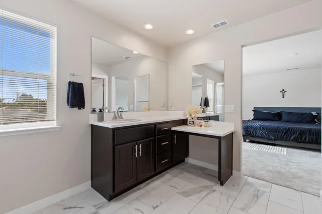 a spacious bathroom with a sink double vanity and a mirror