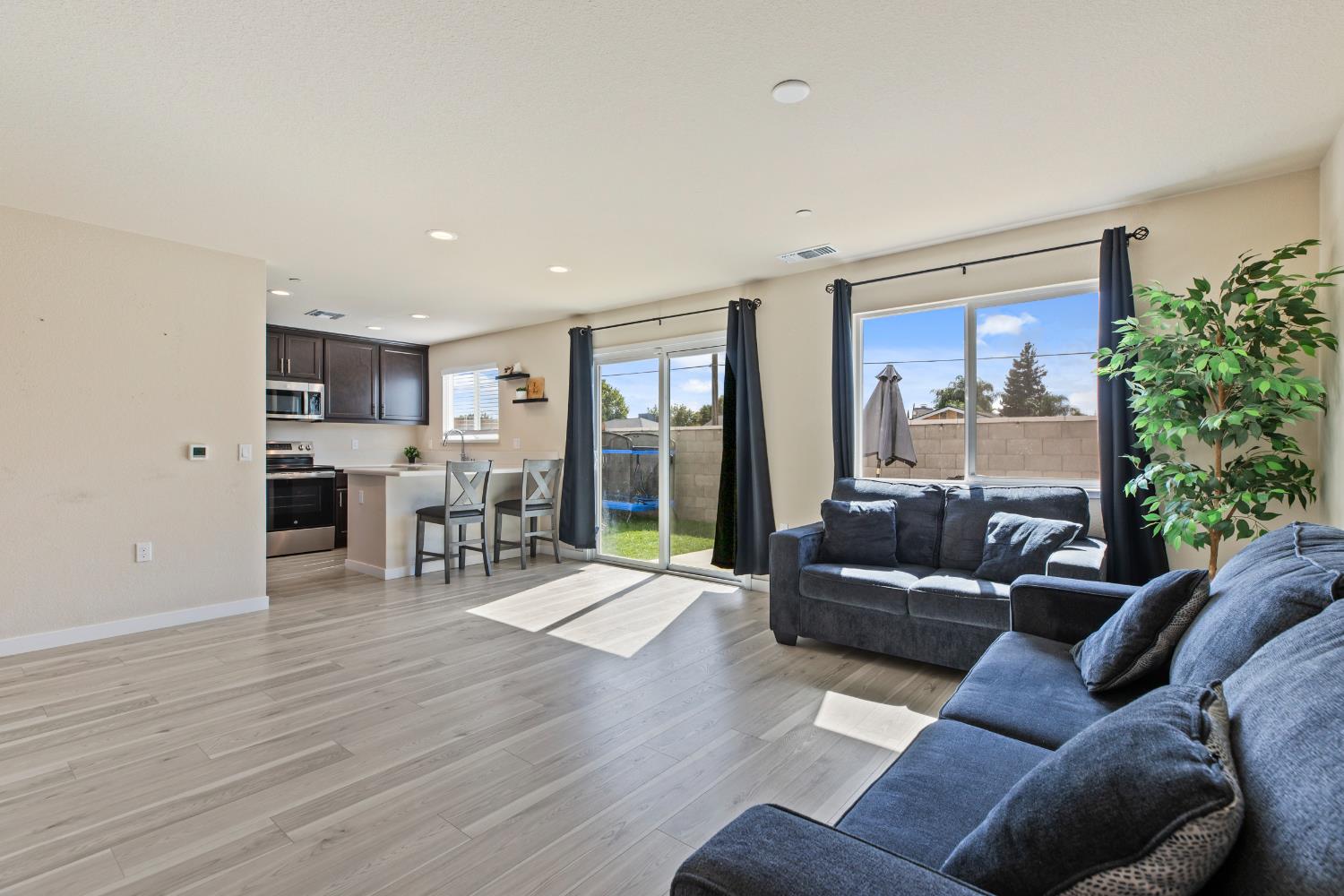 1202 Impression Street Turlock, CA 95380 - Photo 7 of 35 a living room with furniture and a large window