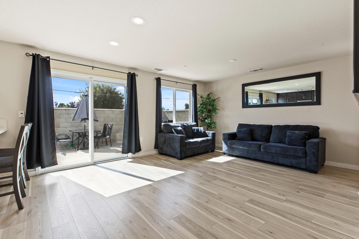 1202 Impression Street Turlock, CA 95380 - Photo 8 of 35 a living room with furniture and a floor to ceiling window
