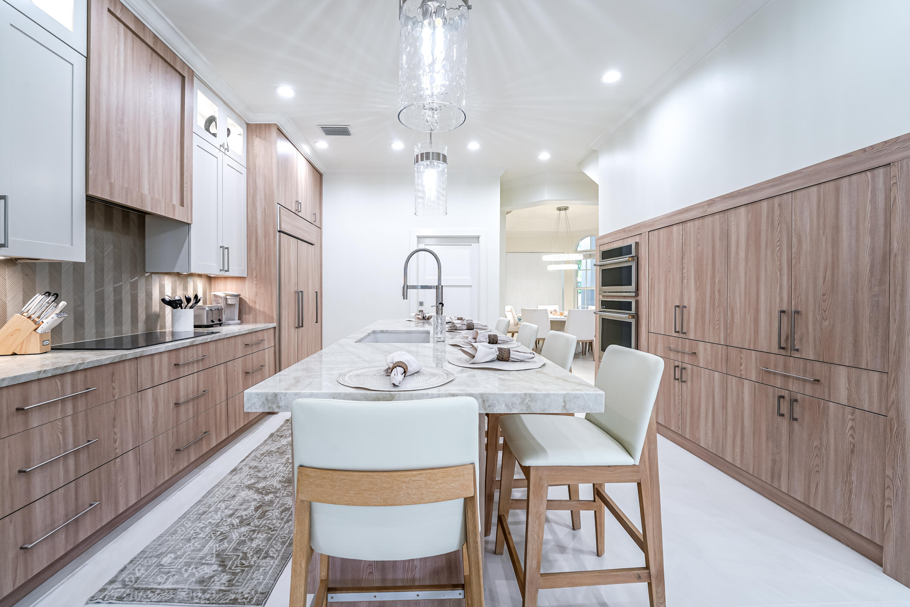 749 Northeast 71st Street Boca Raton, FL 33487 - Photo 10 of 43 a kitchen with stainless steel appliances kitchen island granite countertop a table chairs and a refrigerator