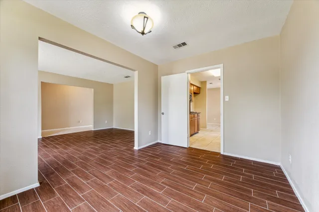 a view of an empty room and wooden floor