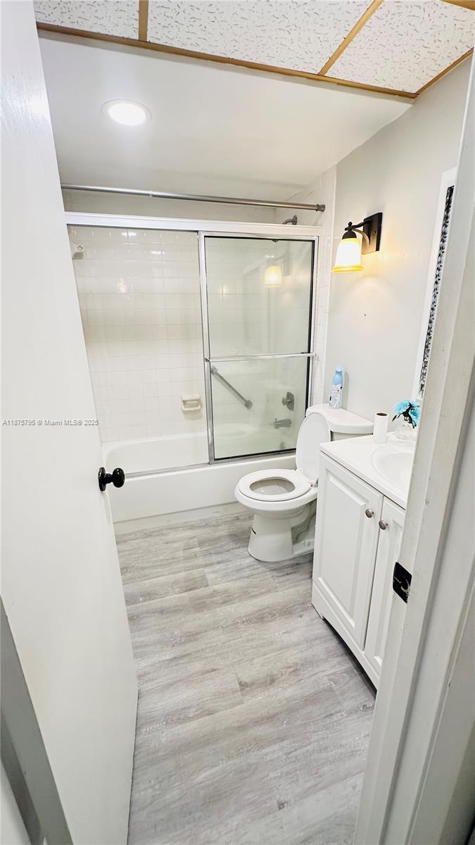 7100 Northwest 17th Street, Unit 111 Plantation, FL 33313 - Photo 12 of 18 a bathroom with a sink a toilet a mirror and shower