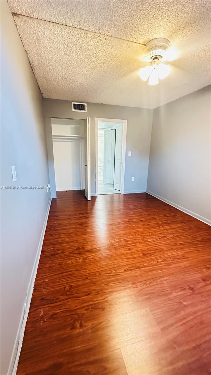 7100 Northwest 17th Street, Unit 111 Plantation, FL 33313 - Photo 14 of 18 a view of an empty room with window and wooden floor