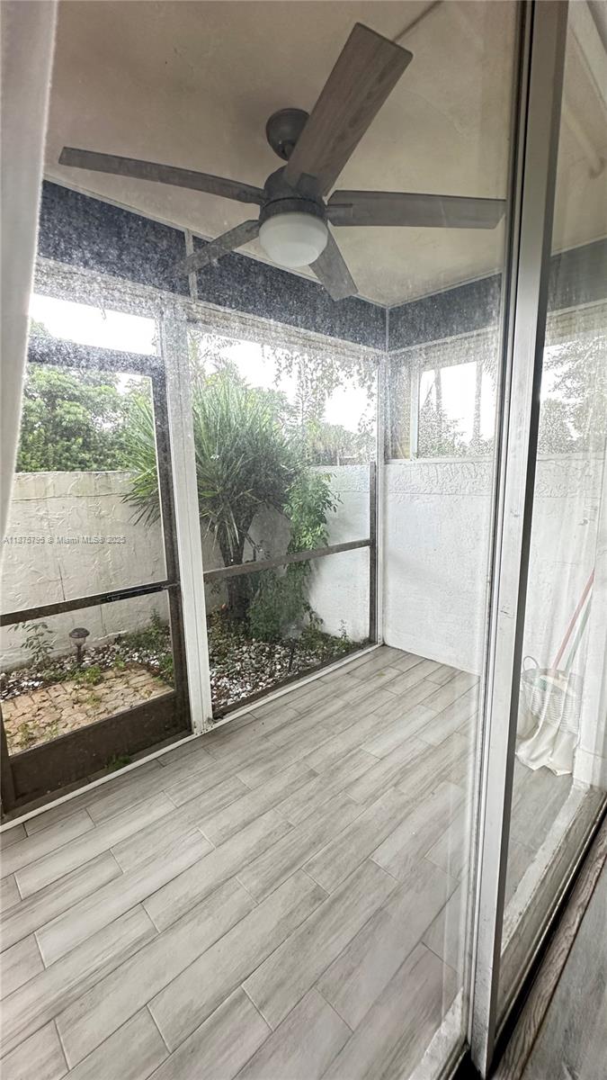 7100 Northwest 17th Street, Unit 111 Plantation, FL 33313 - Photo 4 of 18 a view of empty room with wooden floor and fan