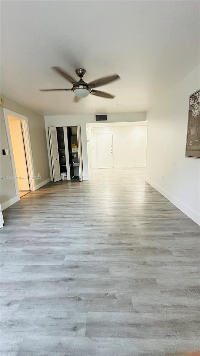 7100 Northwest 17th Street, Unit 111 Plantation, FL 33313 - Photo 6 of 18 wooden floor in an empty room with a window