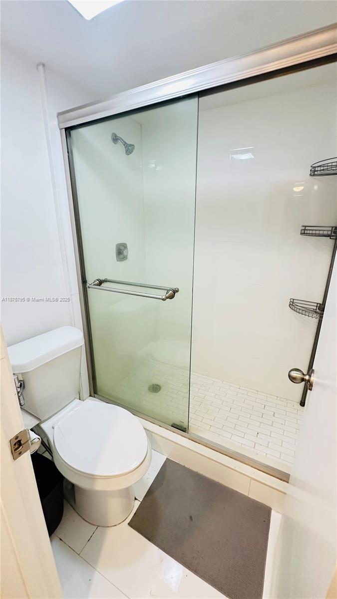 7100 Northwest 17th Street, Unit 111 Plantation, FL 33313 - Photo 10 of 18 a white toilet sitting next to a shower