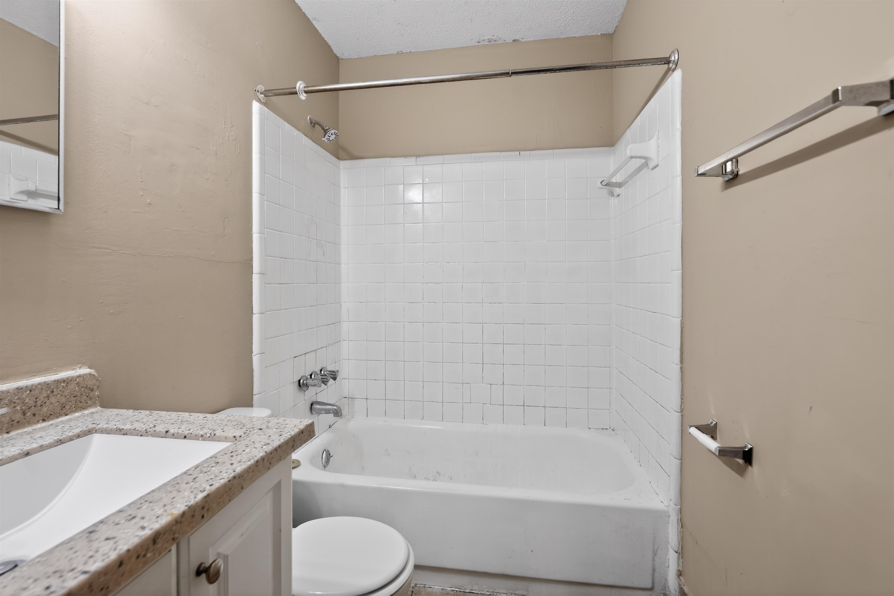 3608 Cane Ridge Drive Memphis, TN 38109 - Photo 26 of 31 Bathroom featuring a shower-tub combination with white subway tile surround, chrome fixtures, and a curved shower rod