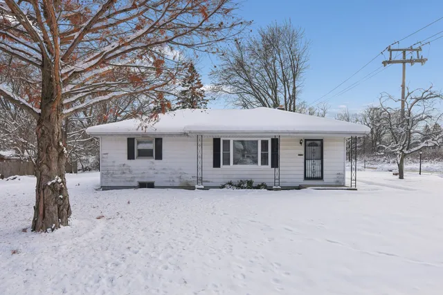 a front view of a house with a covered with snow in front of house