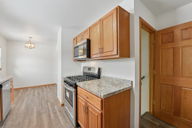 a kitchen with a stove a sink and a refrigerator