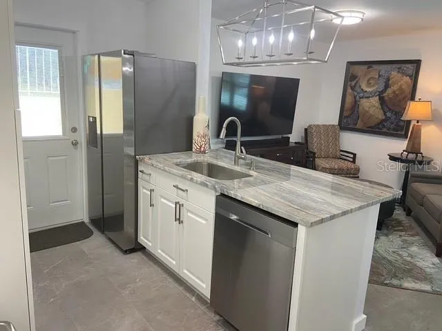 a kitchen with a sink and refrigerator