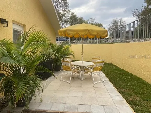 a view of a swimming pool with a table and chairs
