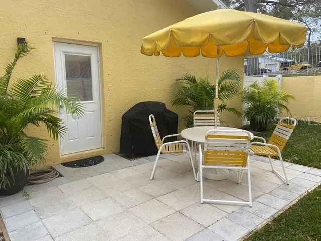 a balcony with table and chairs
