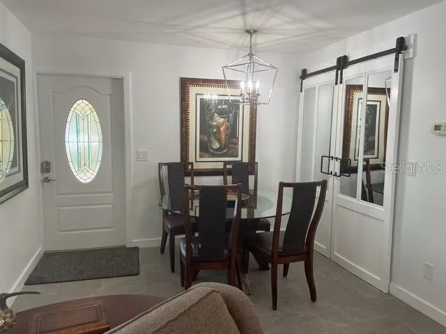 a view of a dining room with furniture and chandelier