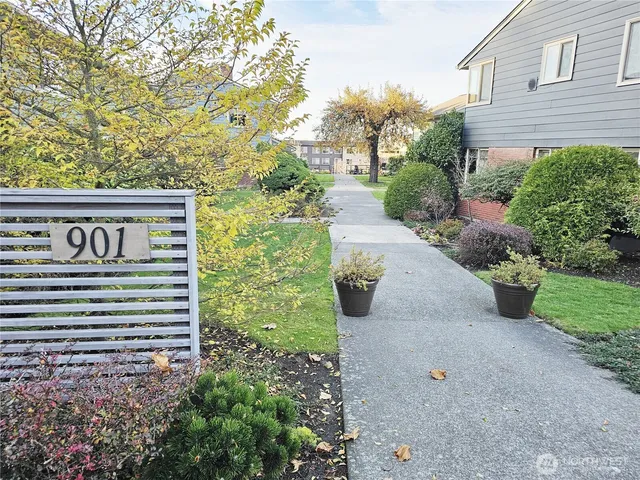 a view of a house with a yard and sitting area