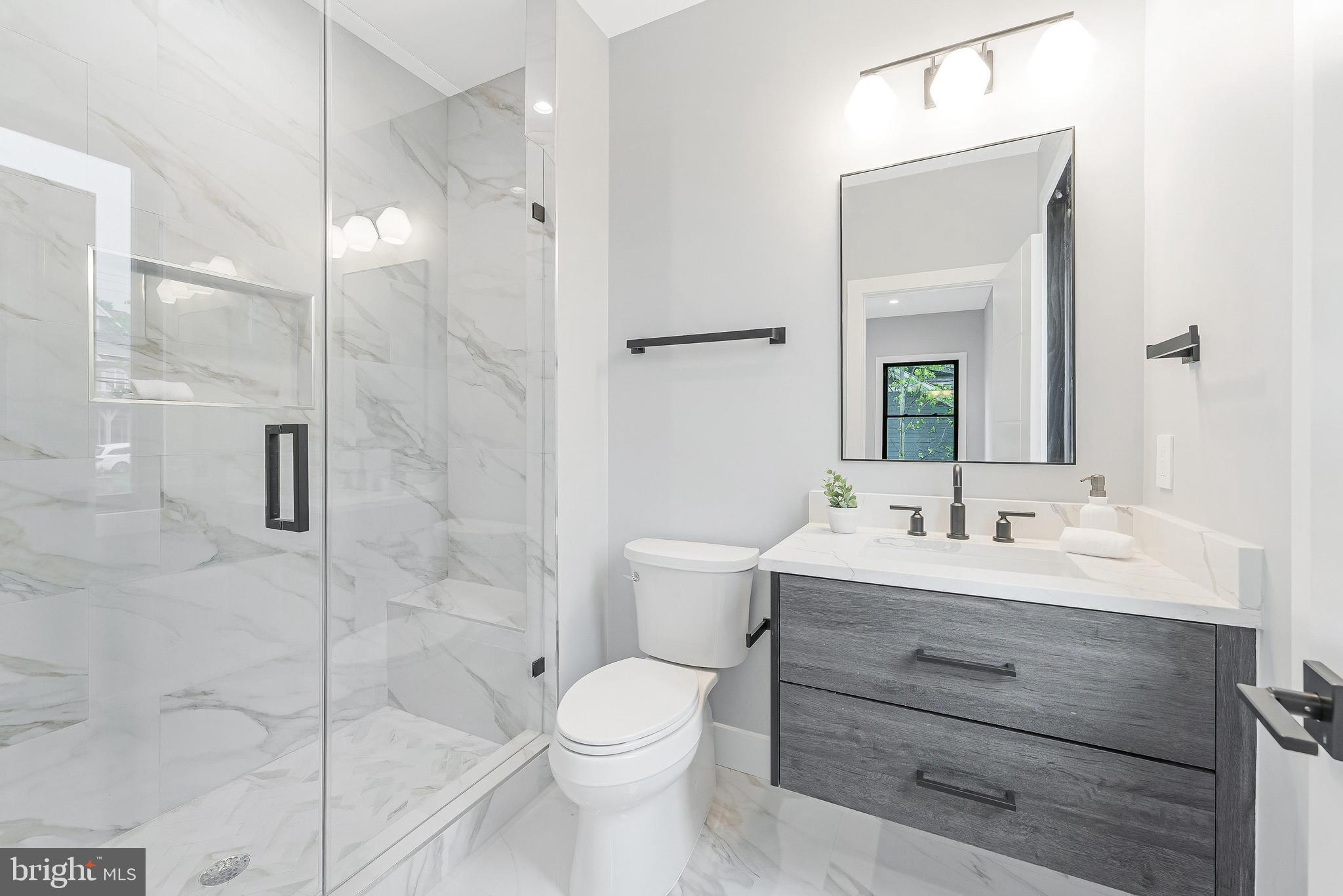 1052 Balls Hill Road McLean, VA 22101 - Photo 30 of 41 a bathroom with a toilet a sink shower and mirror