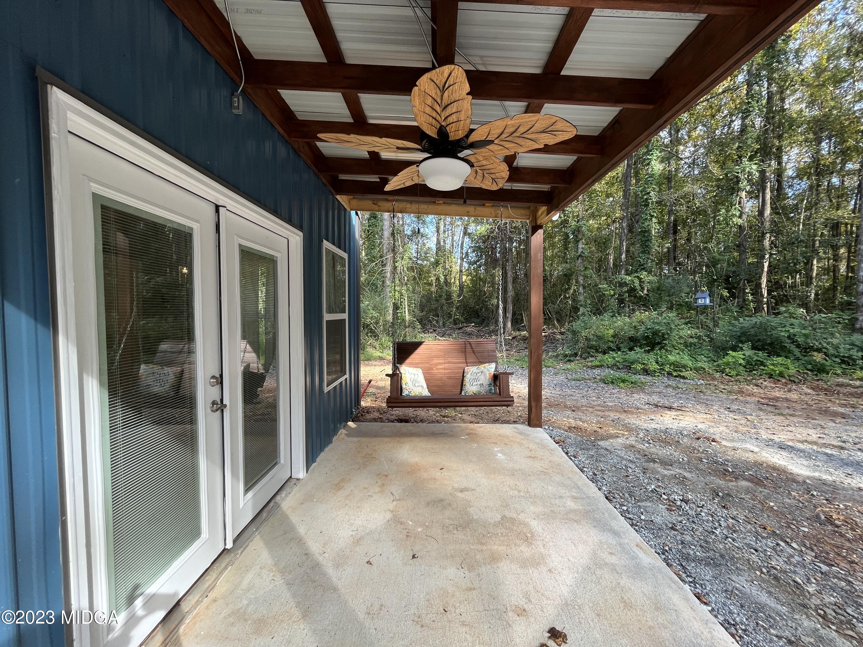 368 Mott Road Barnesville, GA 30204 - Photo 3 of 17 a bed room with a large bed and a chandelier