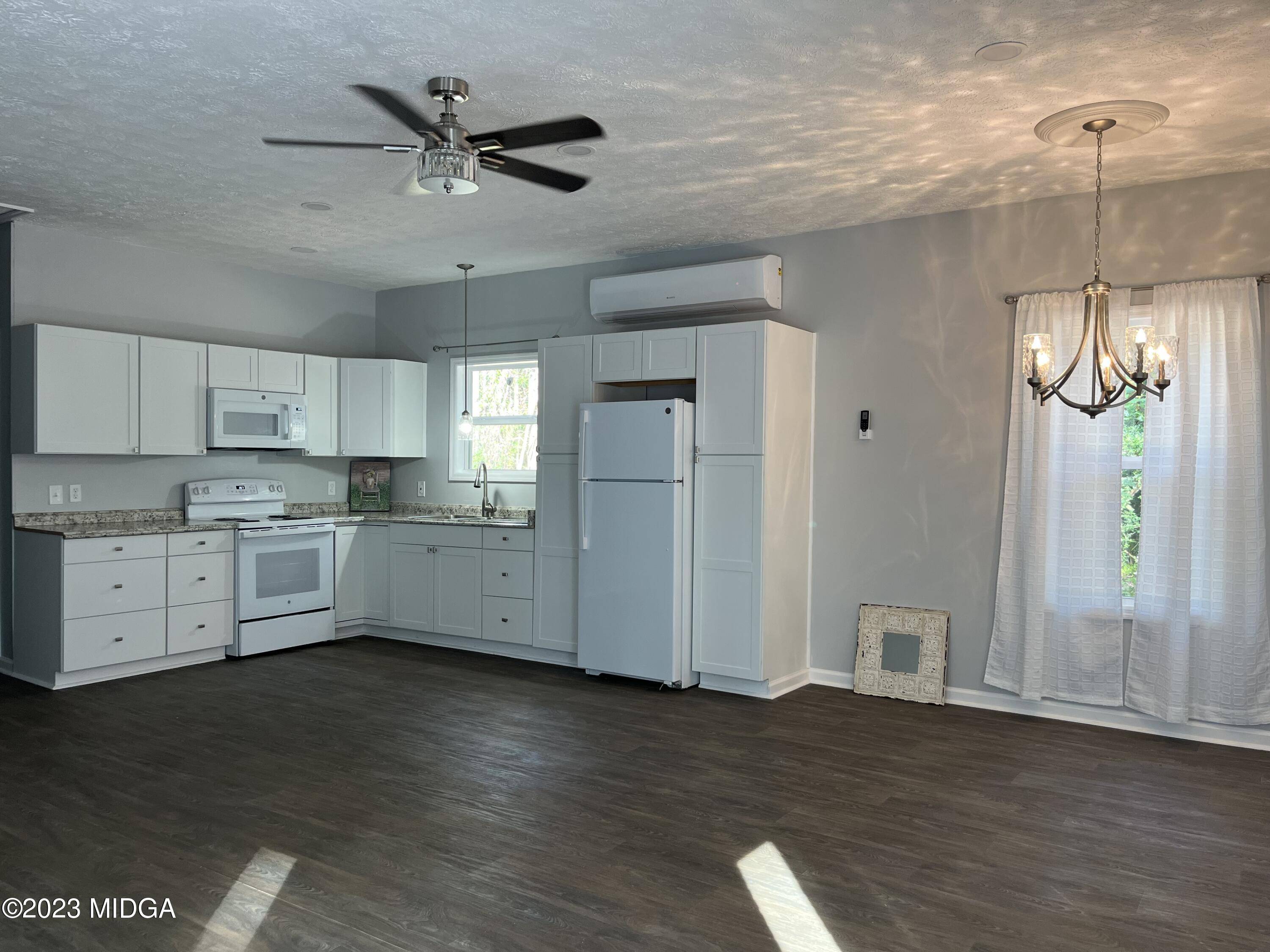 368 Mott Road Barnesville, GA 30204 - Photo 4 of 17 a kitchen view with wooden floor and a window