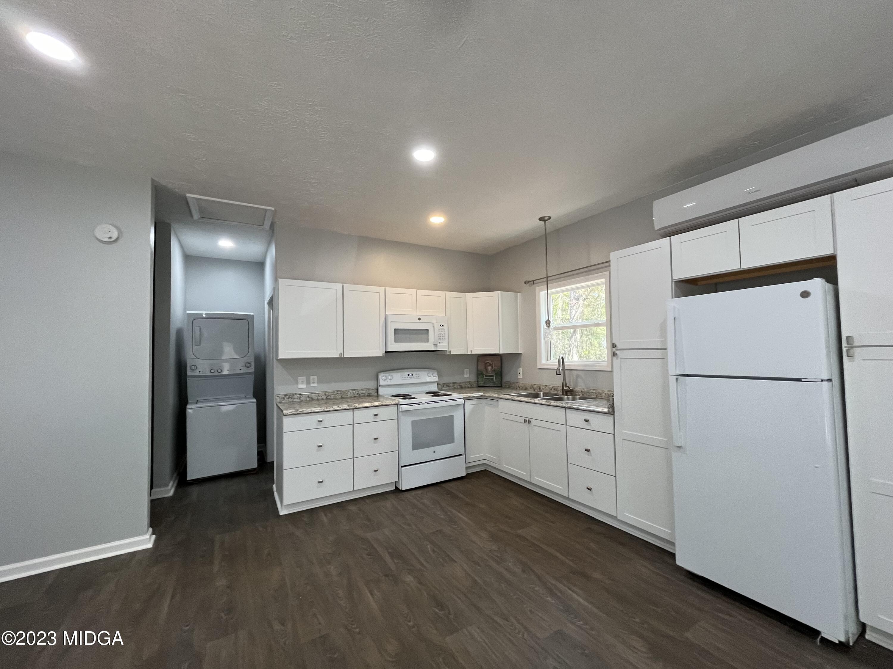 368 Mott Road Barnesville, GA 30204 - Photo 5 of 17 a kitchen with white cabinets and white appliances