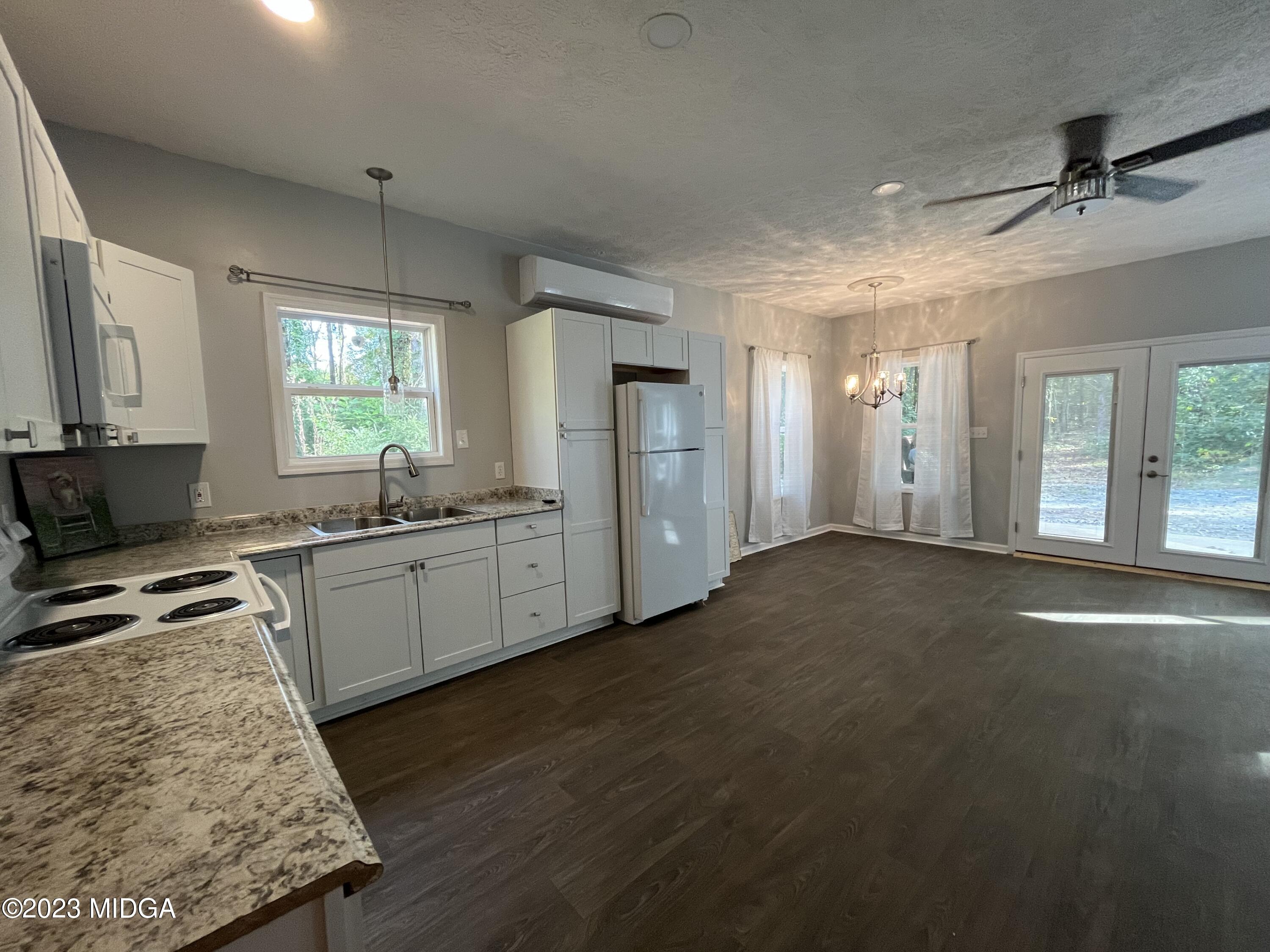 368 Mott Road Barnesville, GA 30204 - Photo 8 of 17 a kitchen with granite countertop a stove a sink and a refrigerator