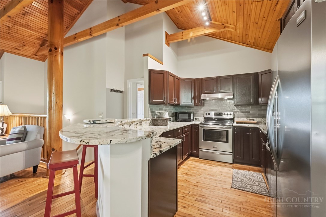 850 River Ridge Road Boone, NC 28607 - Photo 6 of 26 a kitchen with stainless steel appliances granite countertop a stove a sink and a refrigerator