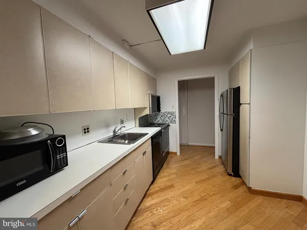 a kitchen with a sink and a stove top oven