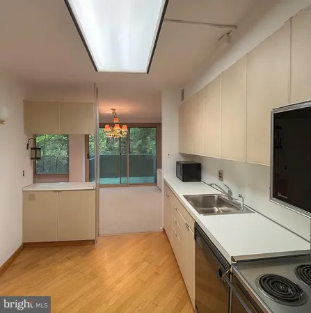 a kitchen that has a sink and a stove