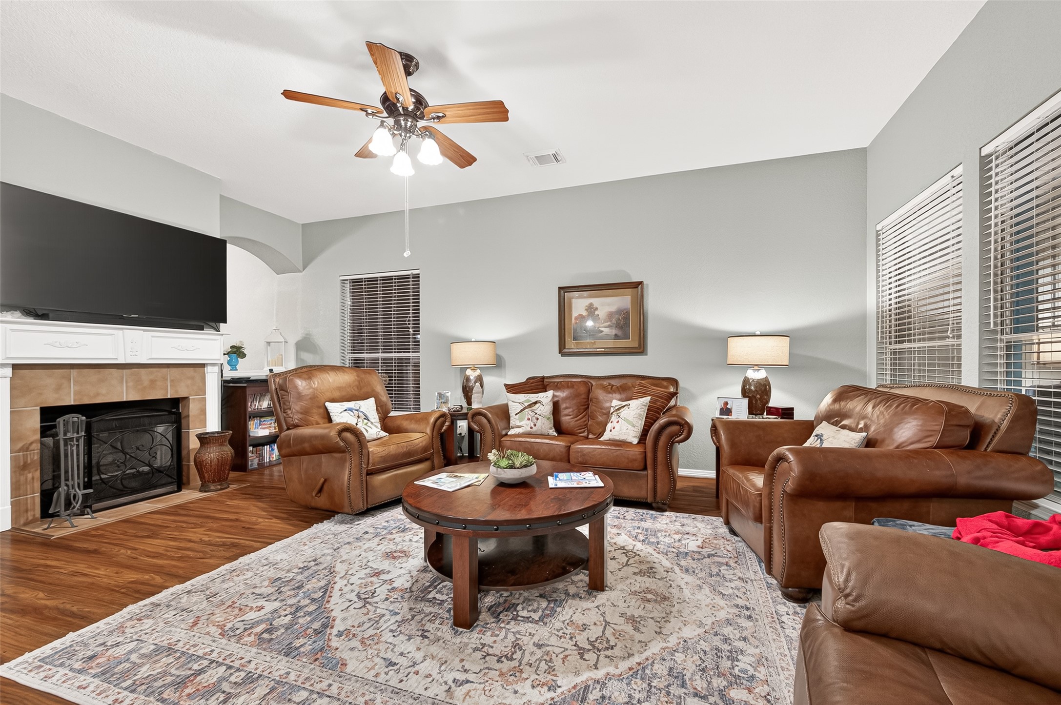12455 West Summerlin Conroe, TX 77302 - Photo 8 of 31 a living room with furniture a flat screen tv and a fireplace
