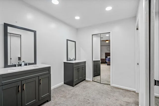 a spacious bathroom with a sink and a mirror