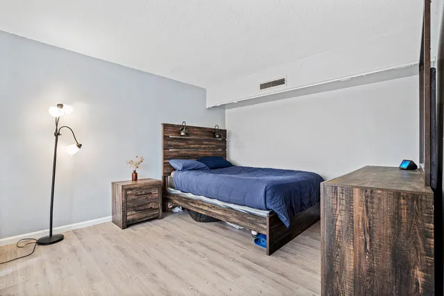 a room with a bed and a dresser