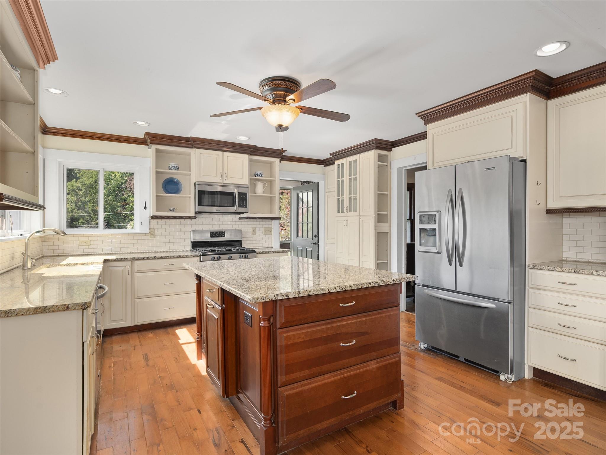 4912 Pigeon Road Waynesville, NC 28786 - Photo 14 of 38 a kitchen with a refrigerator sink and cabinets