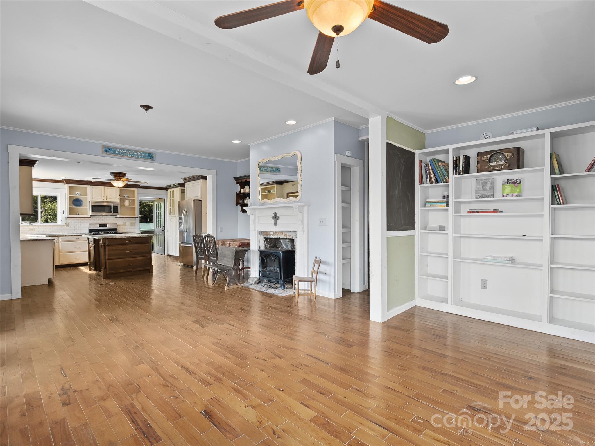 4912 Pigeon Road Waynesville, NC 28786 - Photo 16 of 38 a view of a living room kitchen with stainless steel appliances wooden floor and chair