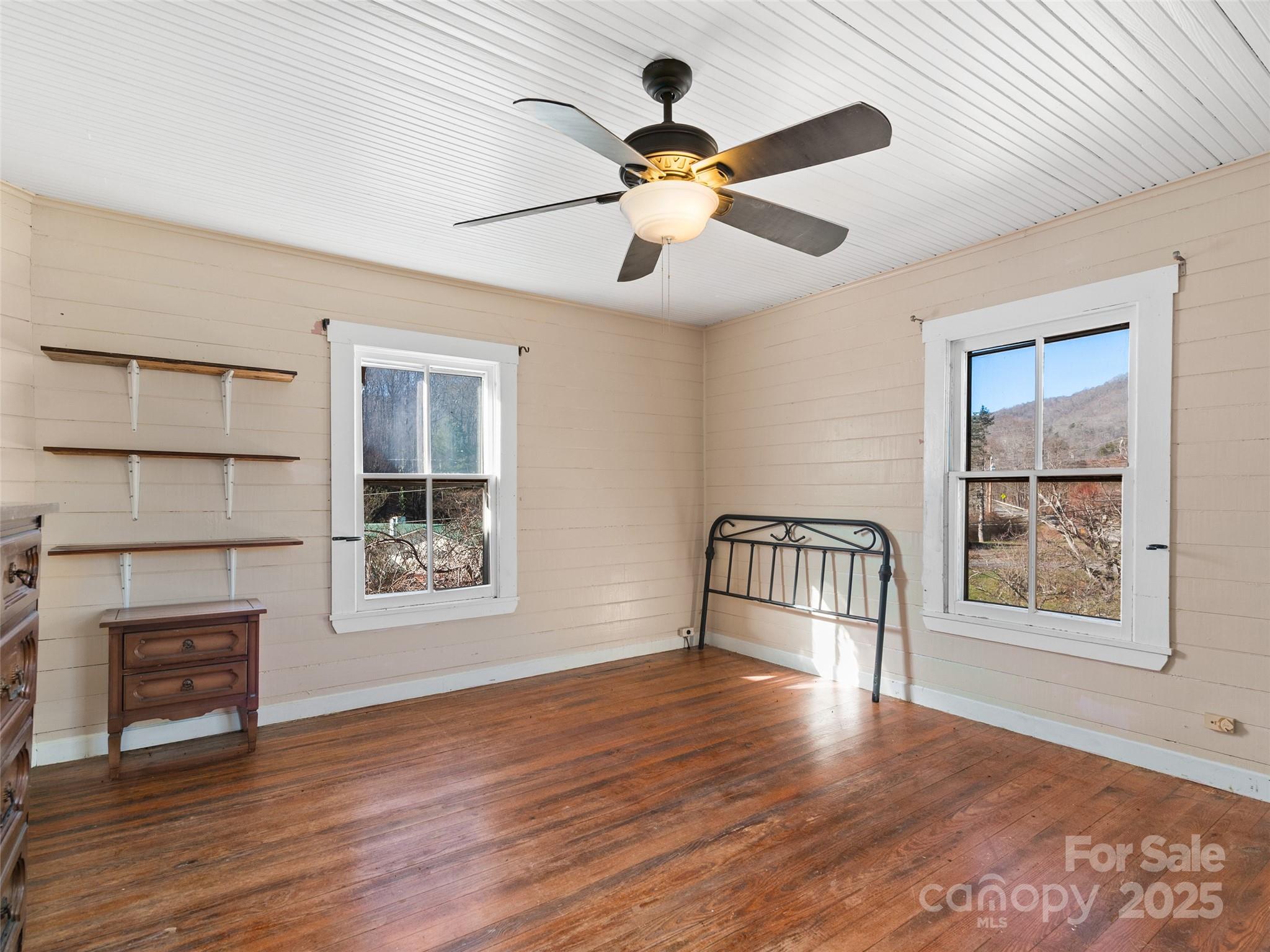 4912 Pigeon Road Waynesville, NC 28786 - Photo 34 of 38 a view of an empty room with wooden floor and a window