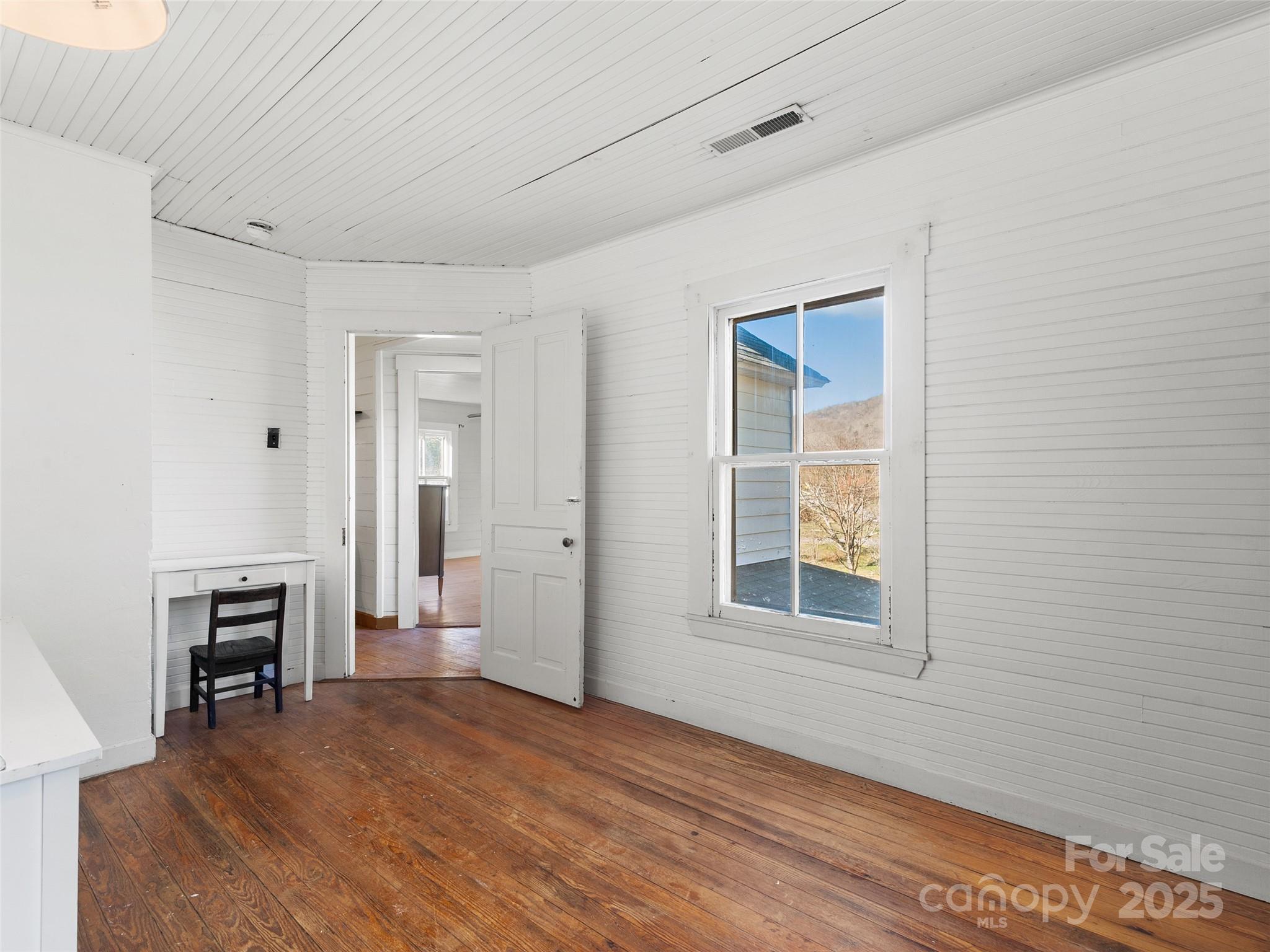 4912 Pigeon Road Waynesville, NC 28786 - Photo 35 of 38 a view of empty room with wooden floor and fan