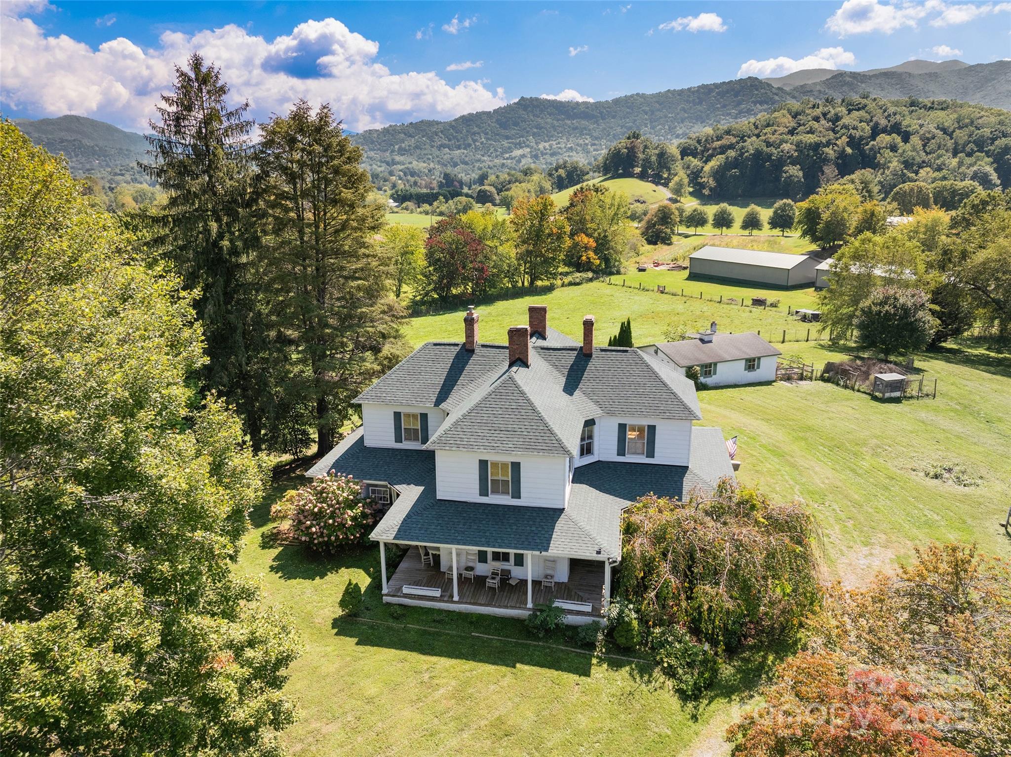 4912 Pigeon Road Waynesville, NC 28786 - Photo 5 of 38 a view of a house with a big yard and large trees