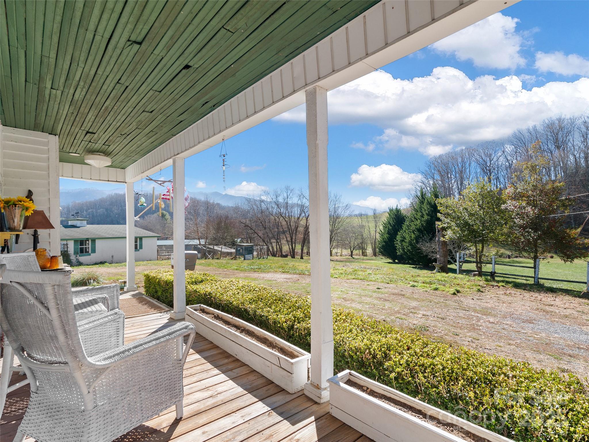 4912 Pigeon Road Waynesville, NC 28786 - Photo 8 of 38 a view of a porch with furniture and garden