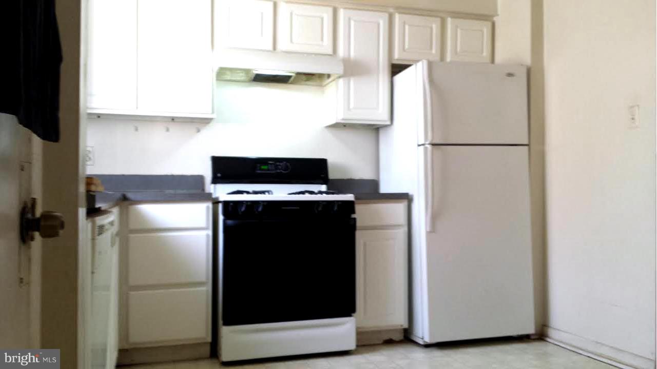 1013 First Street Alexandria, VA 22314 - Photo 2 of 5 a kitchen with a refrigerator and a stove