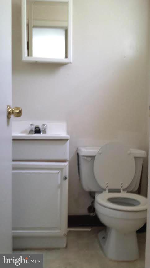 1013 First Street Alexandria, VA 22314 - Photo 3 of 5 a bathroom with a sink a toilet and mirror