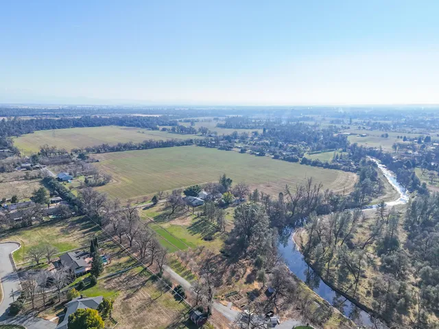 an aerial view of a houses with a lake view