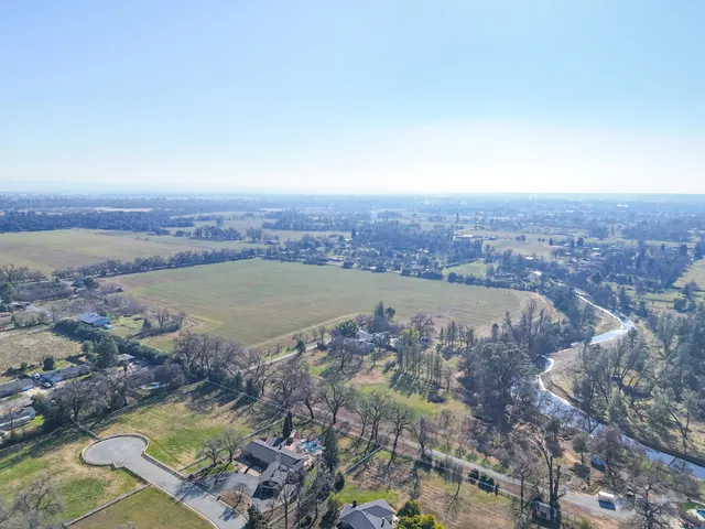 an aerial view of a house with a lake view