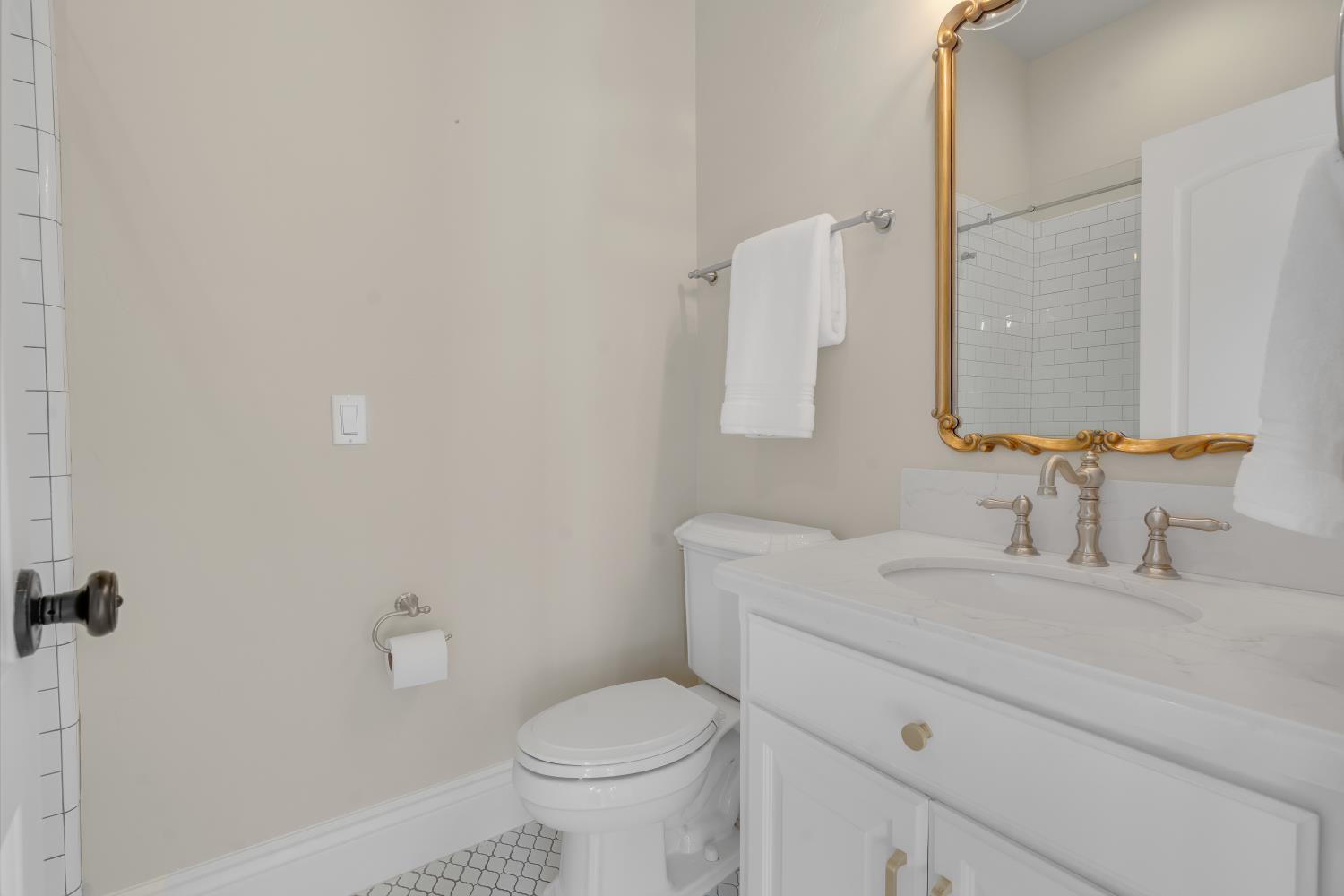 2905 Virginiatown Road Lincoln, CA 95648 - Photo 20 of 86 Bathroom featuring a white vanity with a light-toned countertop, a decorative gold-framed mirror, and a toilet