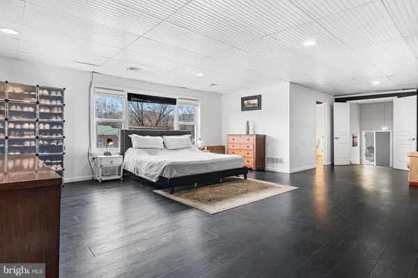 a bedroom with a large bed and a book shelf