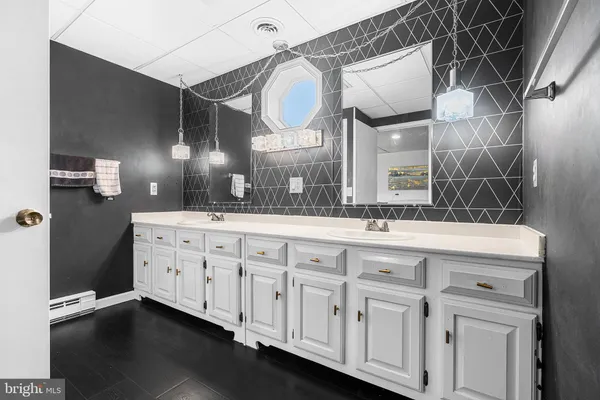 a bathroom with a double vanity sink and a mirror