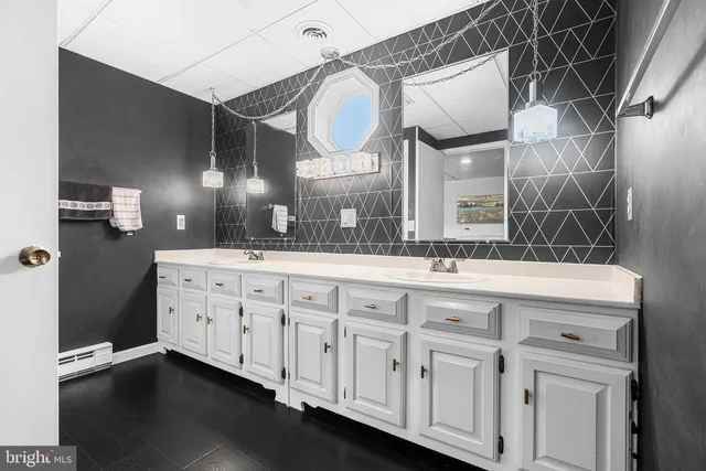 a bathroom with a double vanity sink and a mirror