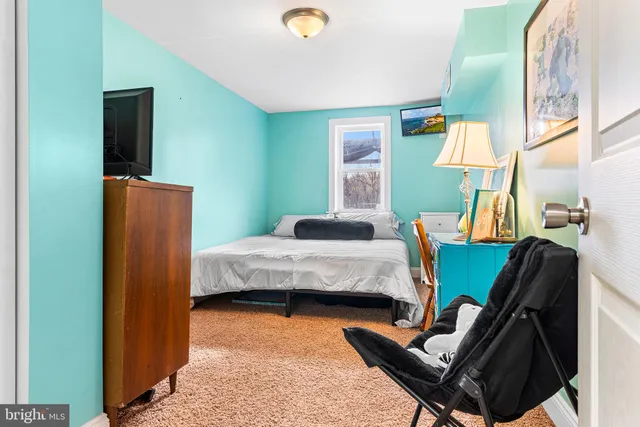 a bedroom with a bed and a lamp