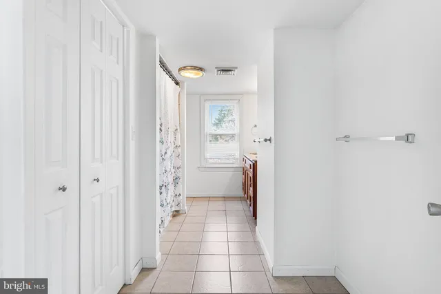 a bathroom with a shower and a sink