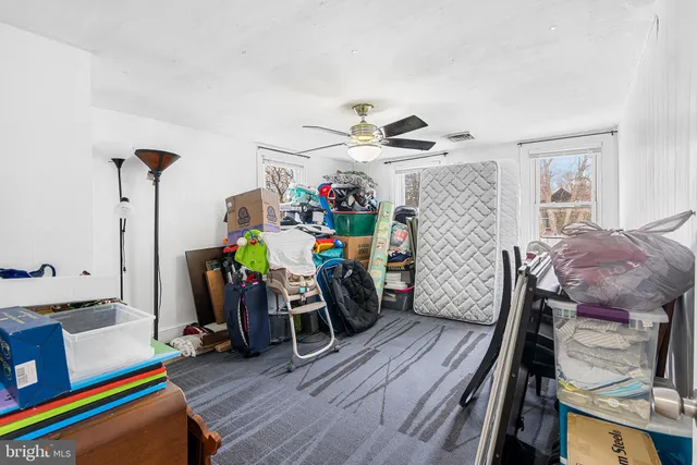 a view of a room with furniture and wooden floor