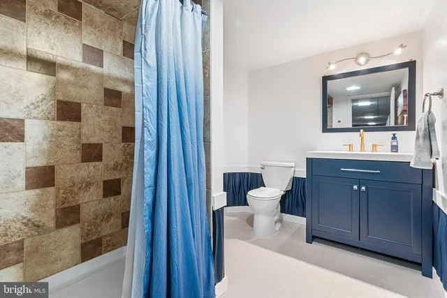 a bathroom with a double vanity sink mirror and shower